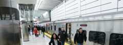 Riders on the platform next to an LIRR train at Grand Central Madison