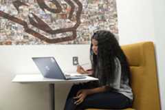 Student concentrating on her work with a computer. 