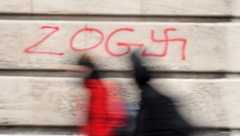 Graffiti reading 'zog' next to a swastika.