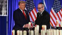 Donald Trump and Yehuda Kaploun light a candle during an Oct. 7 remembrance event at the Trump National Doral Golf Club in Doral, Florida on Oct. 07, 2024. (Joe Raedle/Getty Images)