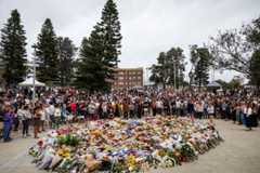 Mourners gather to lay flowers at Bondi Beach in Sydney. Police say 15 people were killed and more than 40 others injured when two attackers opened fire near a Hanukkah celebration at Bondi Beach.