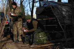 Soldiers with the Ukrainian Army's 10th Mountain Assault Brigade eat lunch during a lull in shelling next to their bunker at the front in the Bakhmut region on December 7. &nbsp;