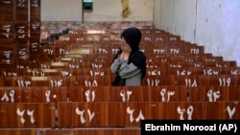 A 19-year old Afghan woman cries on the bench she was sitting on during a suicide bomb attack that killed dozens of her fellow students in a Hazara education center in Kabul on October 1, 2022.