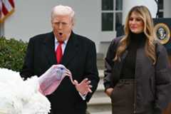 First Lady Melania Trump looks on as US President Donald Trump pardons Gobble, one of the National Thanksgiving turkeys, during the White House turkey pardon ceremony in the Rose Garden of the White House in Washington, DC on November 25, 2025.