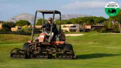 a man mows on a golf course