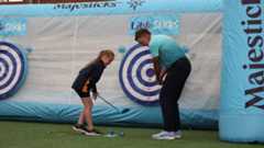 Ian Poulter demonstrates the swing during a Little Sticks session.