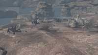 UNSC armored forces engage Covenant Scarabs in the valley.