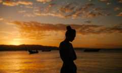 woman standing thinking sunset