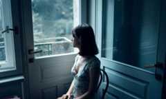 woman sitting thinking beside the door