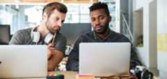 image of two men looking at laptops