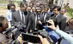 The counsel for Nawaz Sharif briefs journalists outside the court. — AP