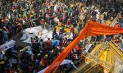 Farmers move barricades during a tractor rally to protest against farm laws on the occasion of India's Republic Day at Tikri border near New Delhi on January 26. &mdash; Reuters