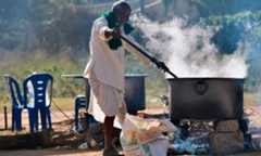 A farmer prepares breakfast for protestors as they continue to demonstrate against the central government's recent agricultural reforms, in Bangalore on January 26. &mdash; AFP