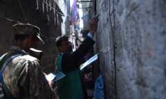 In this file photo, an enumerator marks a house after collecting information from a resident during a census in Karachi. — AFP/File