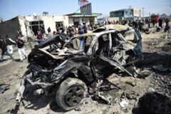 Afghan security personnel and civilians gather next to a damaged car at the site of a car bomb attack in Kabul on March 17, 2018. ─ AFP/File