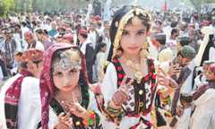 TWO young girls display their dresses, jewellery and henna at a gathering in Hyderabad.—Dawn