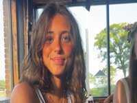 Evelyn Smith Smiling / Evelynsmithhhhh Stare meme depicting a brunette girl smiling and looking at the camera.