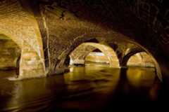 Tunnel arches and Bradford Beck River underground in Bradford, England