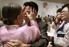 an old woman touching the face of a young man