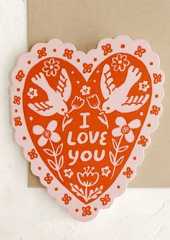A heart shaped card in pink and red with scalloped edges and doves pattern, text on front reads I Love You.