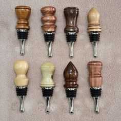 eight wine stoppers are lined up on the carpet