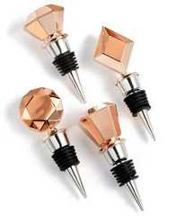 four rose gold and black diamond shaped wine stoppers with screws on white background