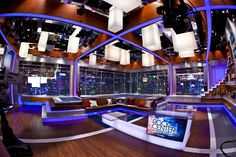 an empty room with couches and televisions in it