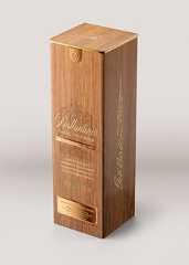 a wooden box with gold lettering on the front and side, sitting on a white surface