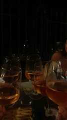 four people holding up wine glasses in front of them