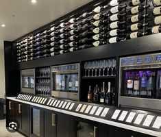 there is a wine bar with many bottles on it