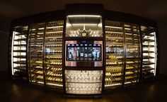 a wine cellar filled with lots of bottles and glasses