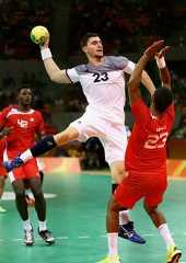 two men in red and white uniforms playing basketball