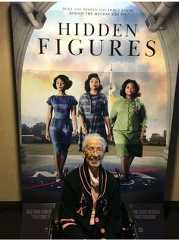 an older woman sitting in front of a poster for the movie'hidden figures '