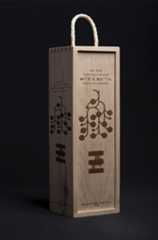 a wooden wine box with rope handles on a black background in the shape of a bag