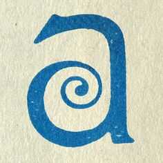 a close up of a blue letter on a white background