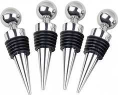 four silver and black balls on top of each other with long needles in the middle