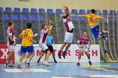 a group of men playing a game of soccer on top of a hard surface court