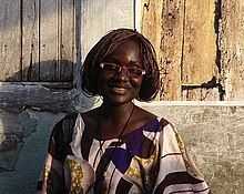 a woman standing in front of a wooden door