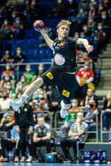 a man is jumping in the air with a ball