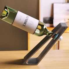 a bottle of wine is being held in the shape of a scissor on a table