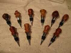 six different types of wine stoppers sitting on top of a white cloth covered table