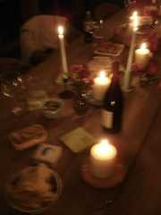 the table is set with wine, bread and candles