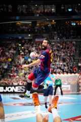 a man jumping in the air to catch a ball during a game with people watching