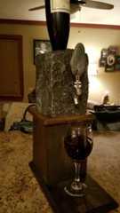 a glass of wine sitting on top of a stone block