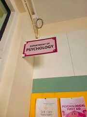 a sign hanging from the side of a wall that says department of pschology