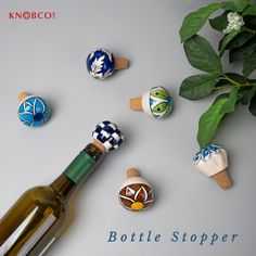 an image of wine bottle stoppers with flowers and leaves on the table next to it