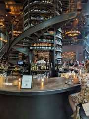 people are sitting at the bar with drinks