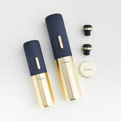 two blue and gold electronic devices sitting next to each other on a white surface,