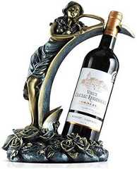 a bottle of wine sitting on top of a statue