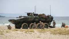 US Marines egress an Amphibious Combat Vehicle to secure the beach at Hwajin-ri, South Korea, during a simulated amphibious assault